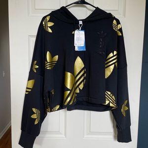 Oversized ADIDAS women’s black and gold cropped hoodie.